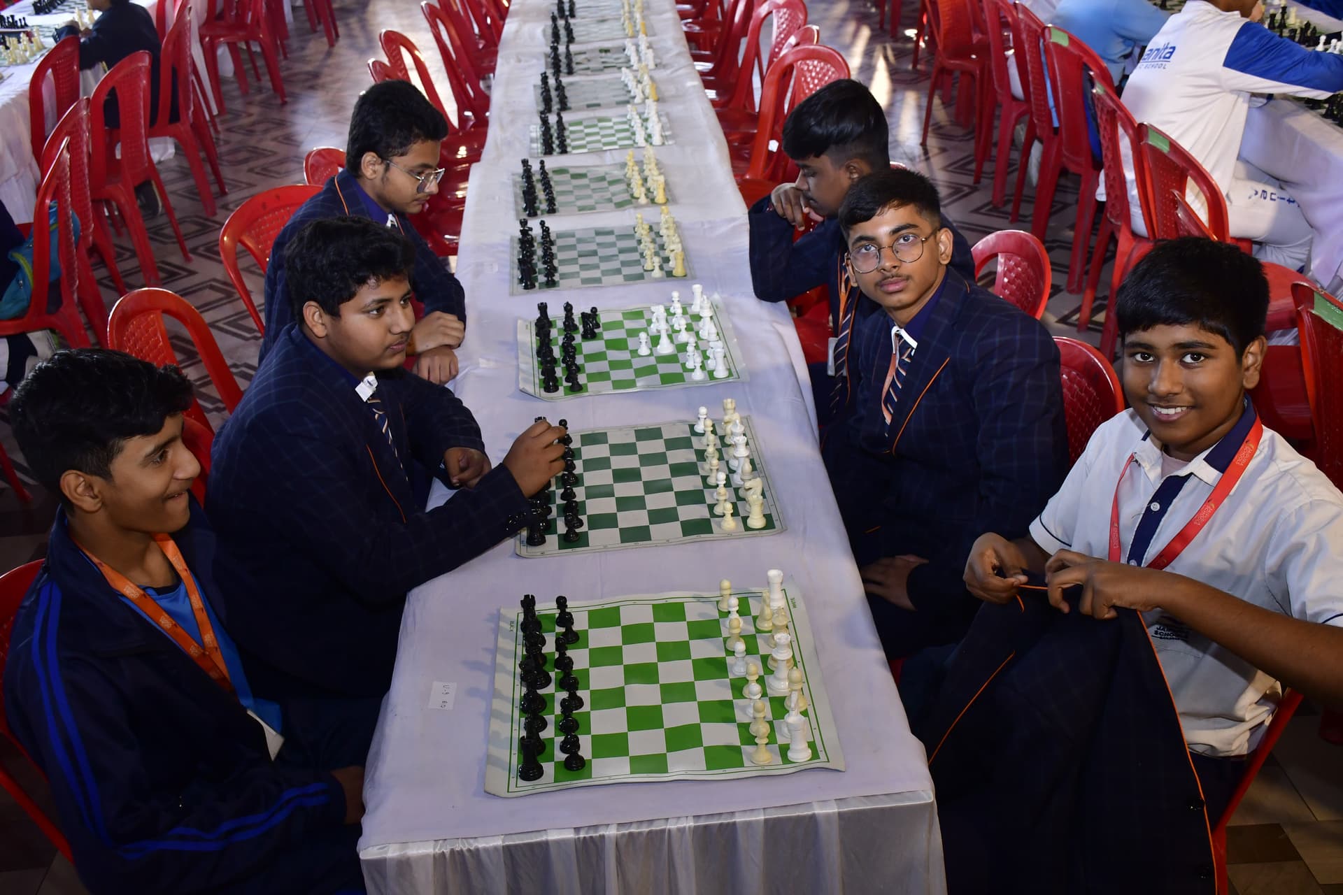 Students playing chess and focusing on their strategy at the Bal Vidyalaya Chess Championship event.