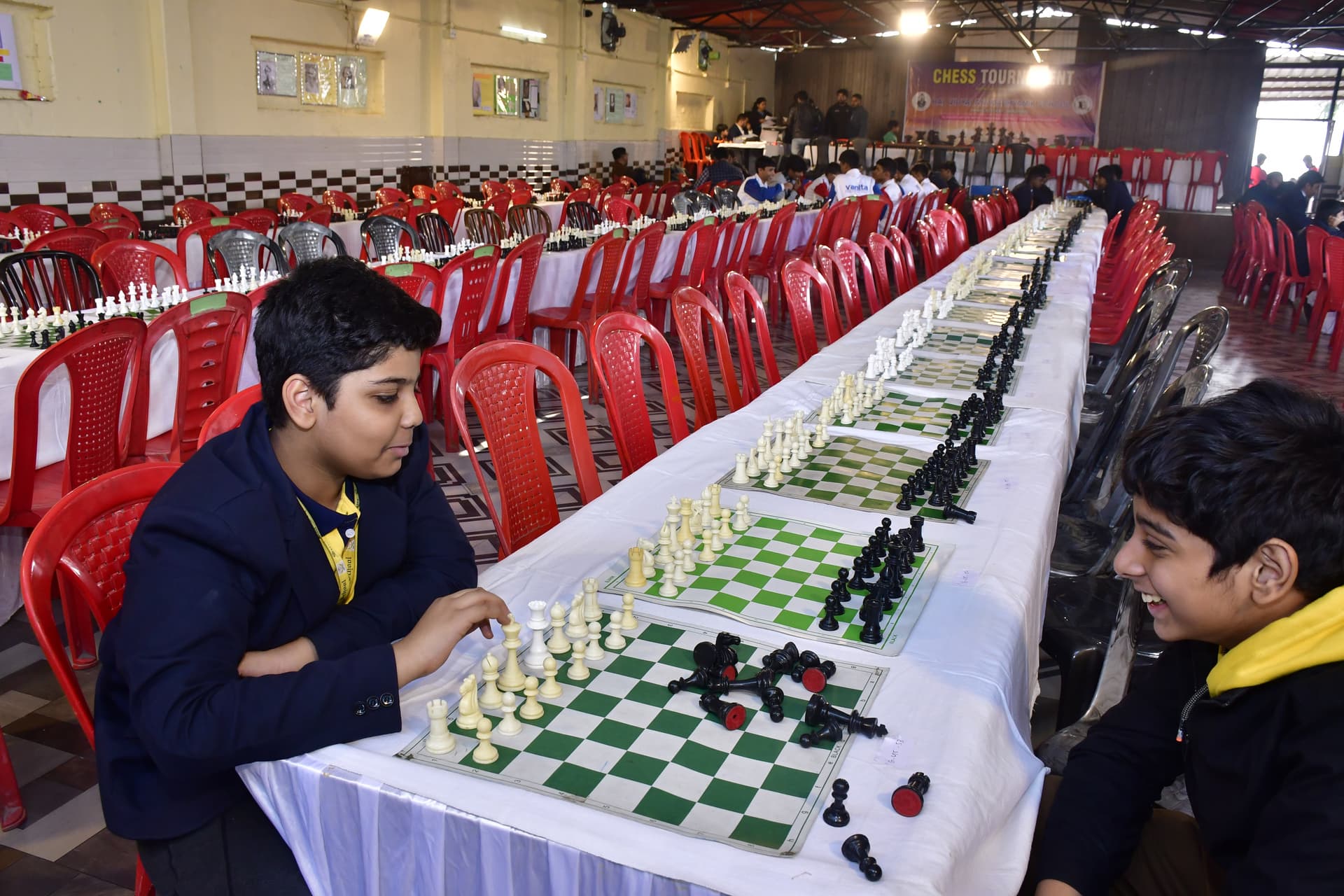 Students playing chess and focusing on their strategy at the Bal Vidyalaya Chess Championship event.