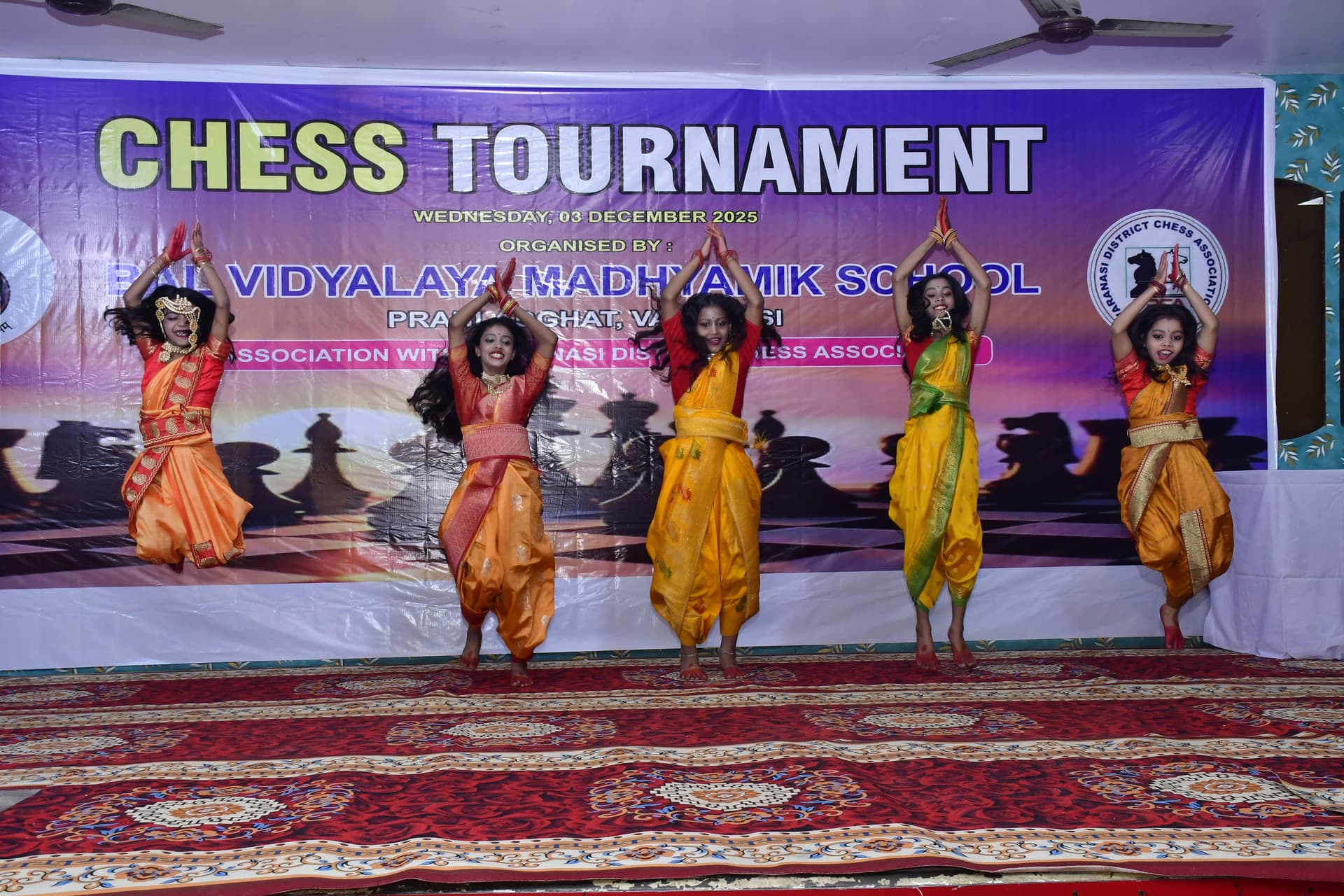 Students playing chess and focusing on their strategy at the Bal Vidyalaya Chess Championship event.