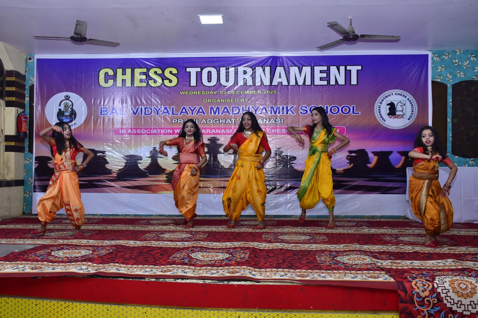 Students playing chess and focusing on their strategy at the Bal Vidyalaya Chess Championship event.