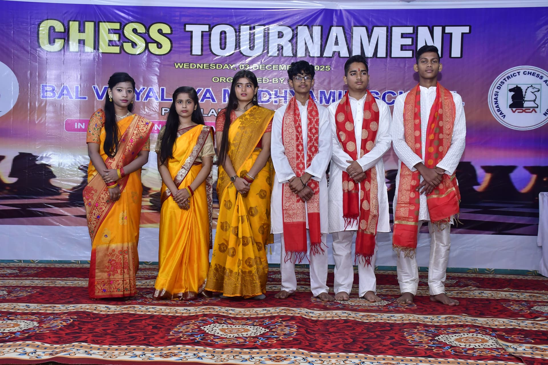 Students playing chess and focusing on their strategy at the Bal Vidyalaya Chess Championship event.