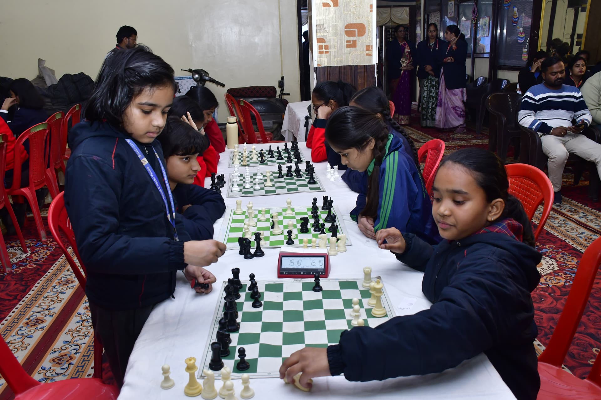 Students playing chess and focusing on their strategy at the Bal Vidyalaya Chess Championship event.
