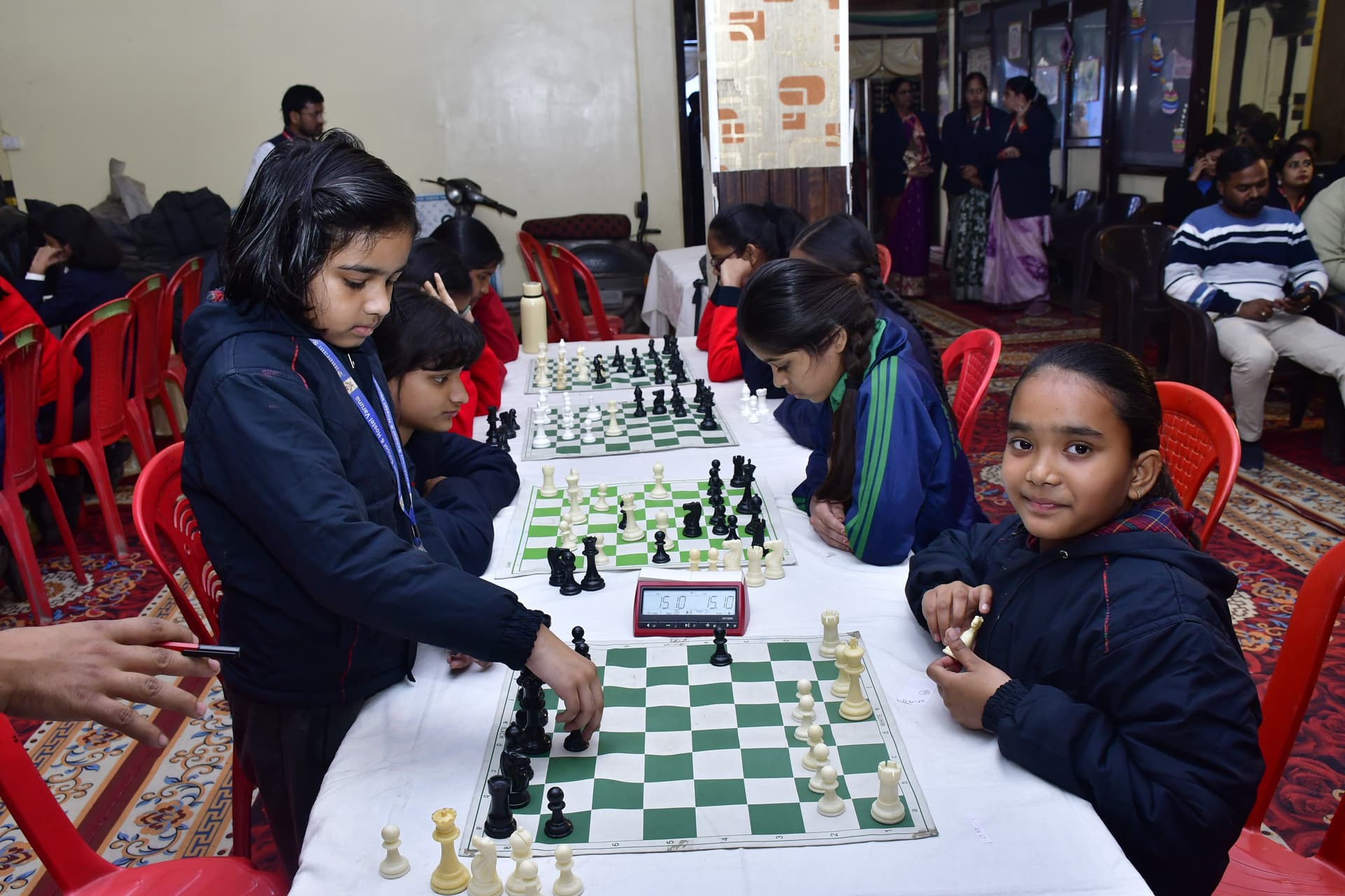 Students playing chess and focusing on their strategy at the Bal Vidyalaya Chess Championship event.