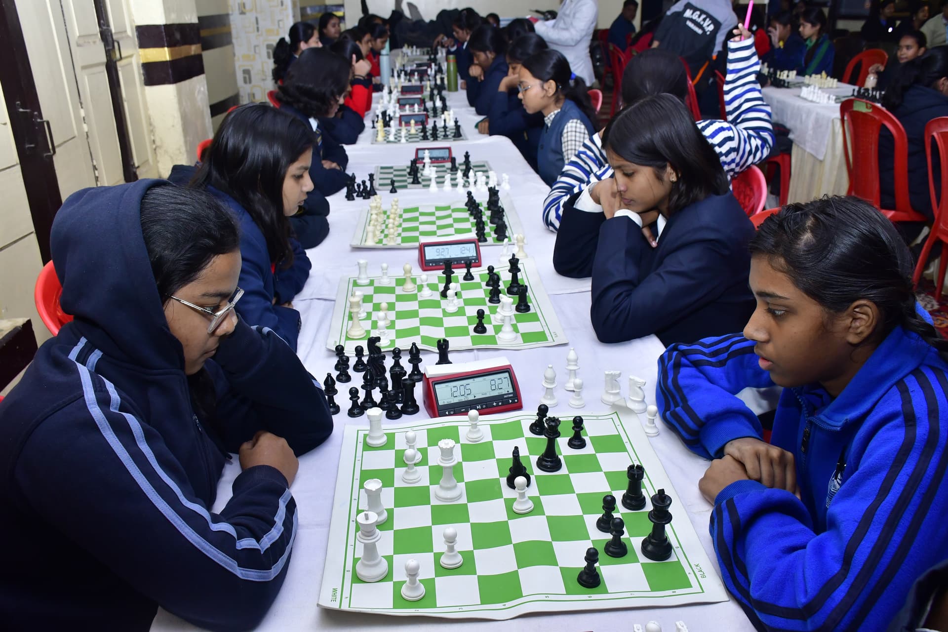 Students playing chess and focusing on their strategy at the Bal Vidyalaya Chess Championship event.