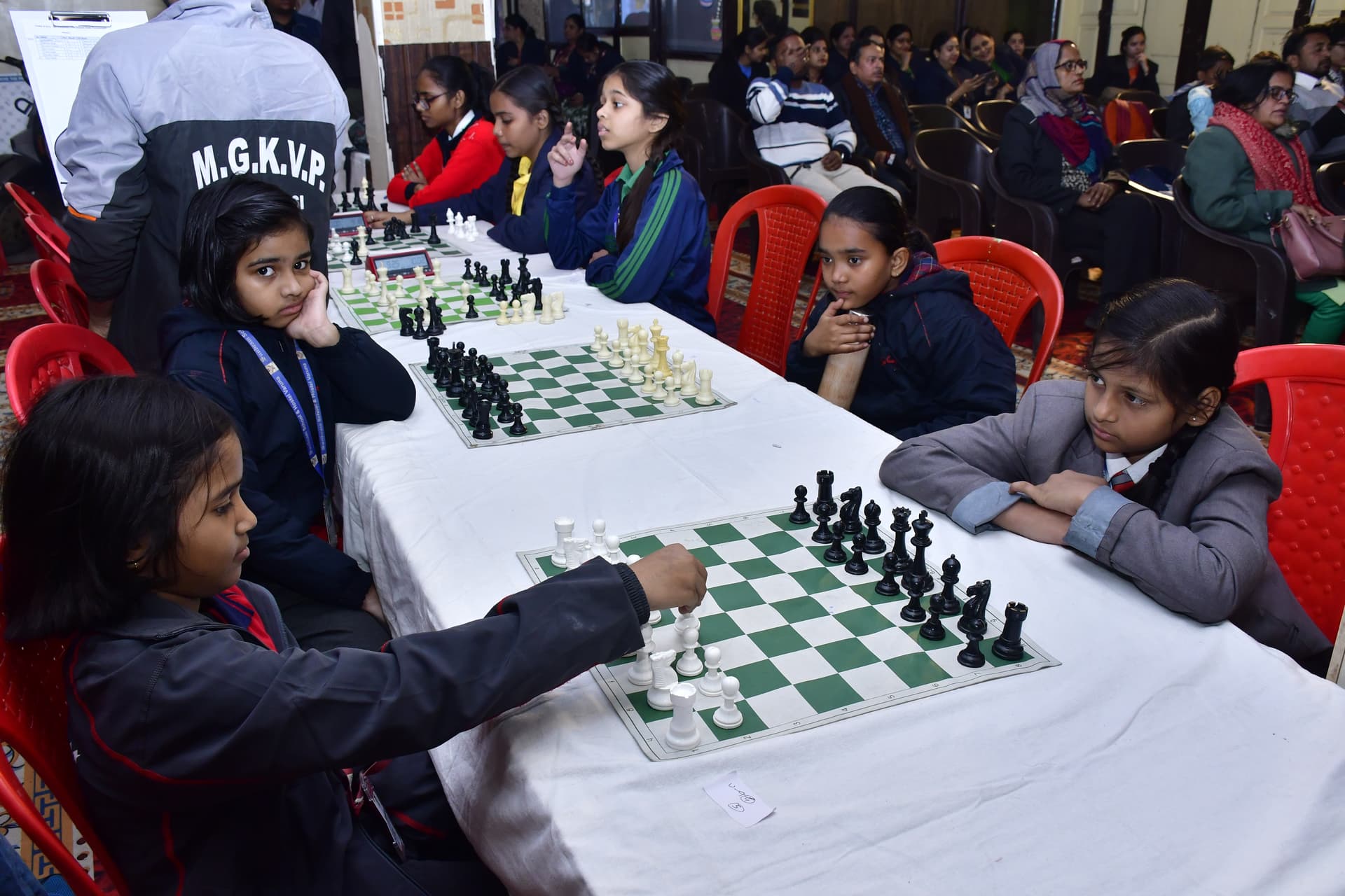 Students playing chess and focusing on their strategy at the Bal Vidyalaya Chess Championship event.