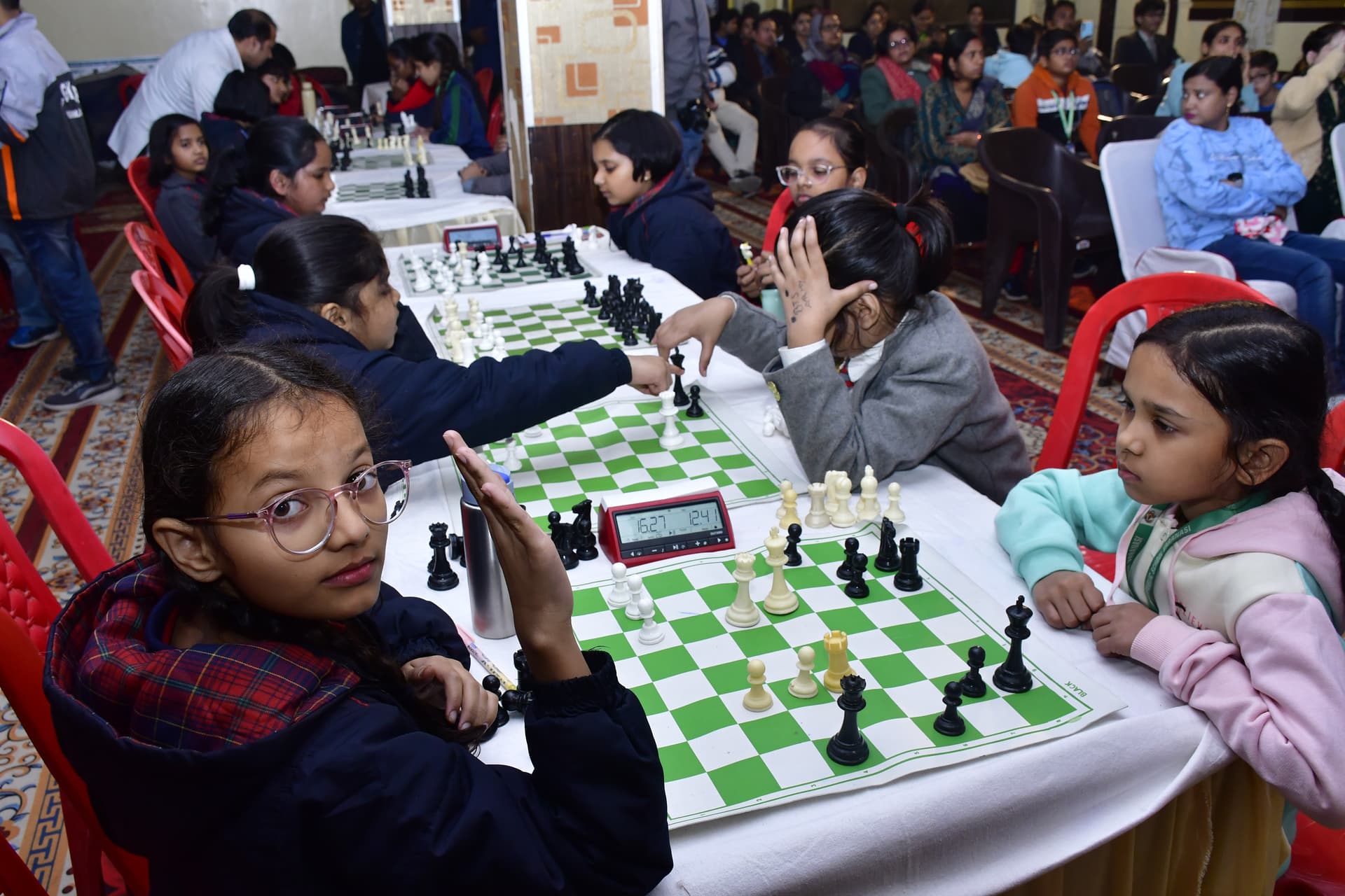 Students playing chess and focusing on their strategy at the Bal Vidyalaya Chess Championship event.