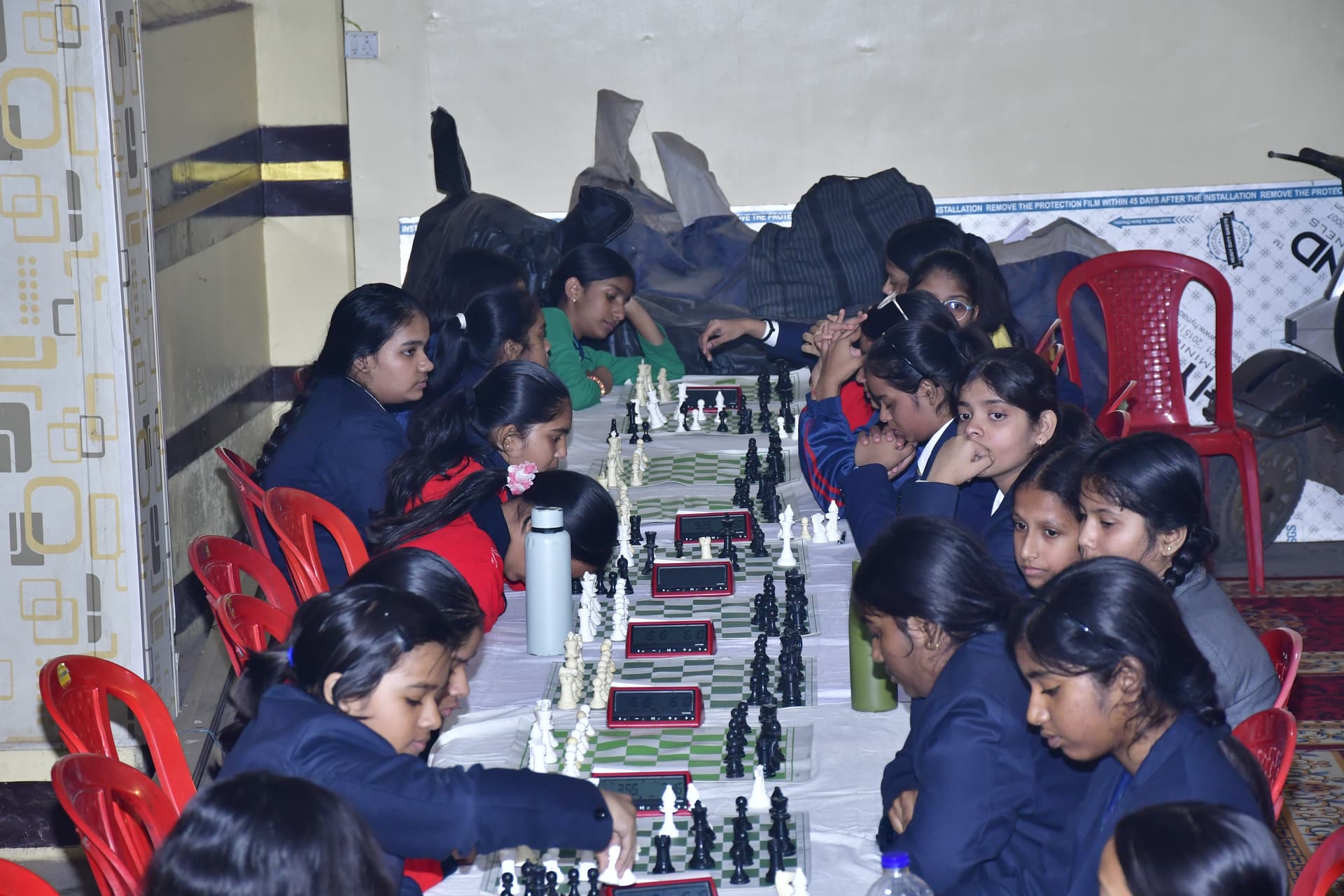 Students playing chess and focusing on their strategy at the Bal Vidyalaya Chess Championship event.